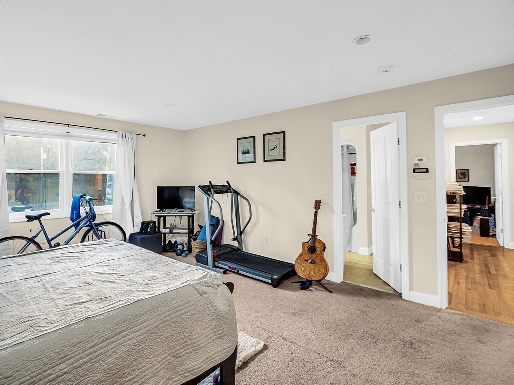 168 Proctor Road Chelmsford, MA 01824 - Photo 23 of 41 a bedroom with filled bed and a desk