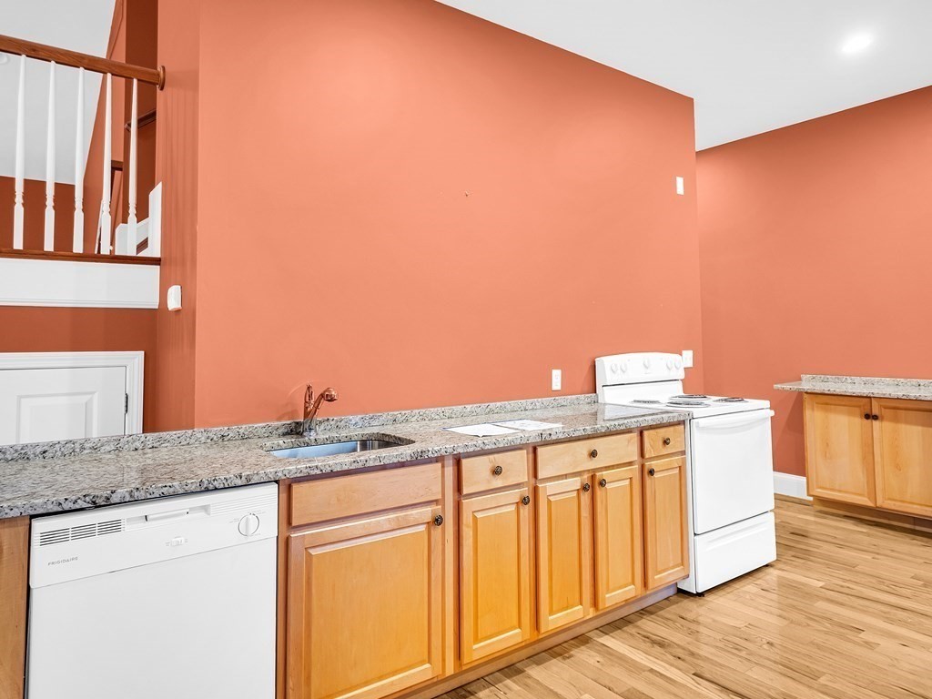 168 Proctor Road Chelmsford, MA 01824 - Photo 7 of 41 a view of a kitchen with granite countertop cabinets and wooden floor