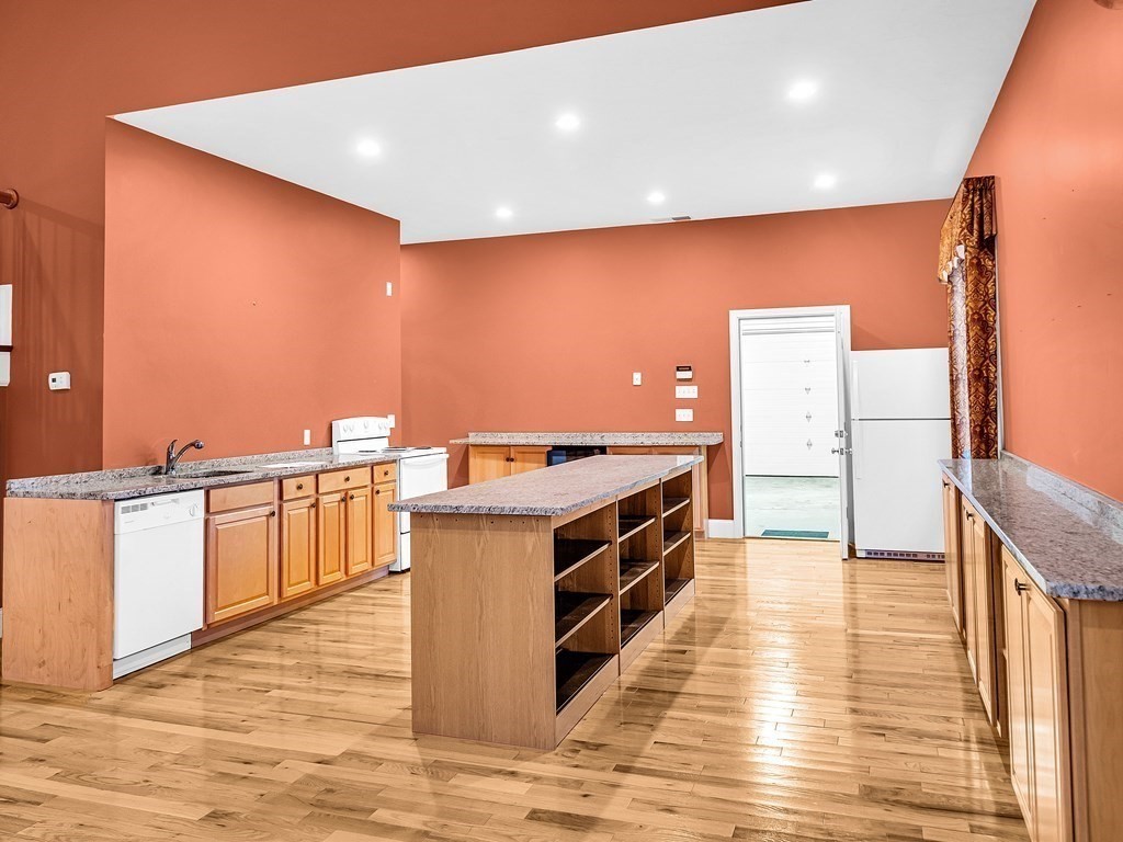168 Proctor Road Chelmsford, MA 01824 - Photo 8 of 41 a kitchen with stainless steel appliances a sink cabinets and wooden floor