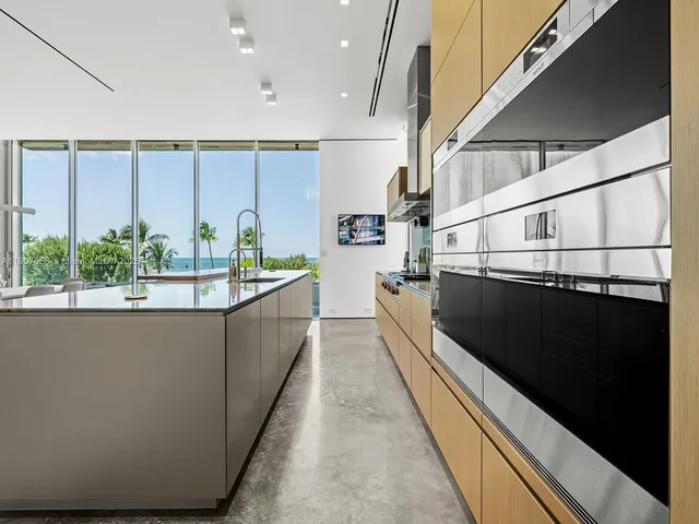 a view of a kitchen with a large window