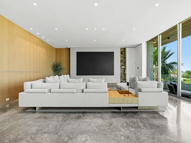 a living room with large couches and flat screen tv