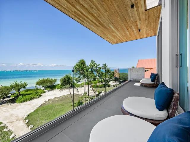 a view of a balcony dining table and chairs