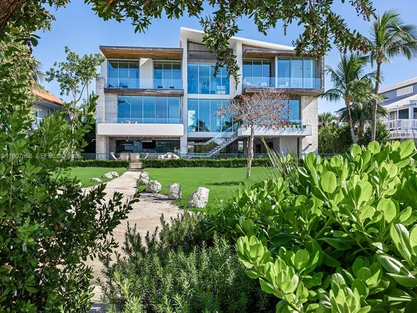 a view of a house with pool and chairs