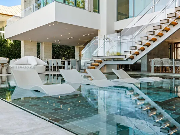 a view of swimming pool with seating area