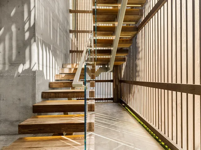 a view of entryway with wooden floor and front door