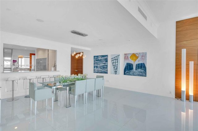 a view of an chairs and table in a room