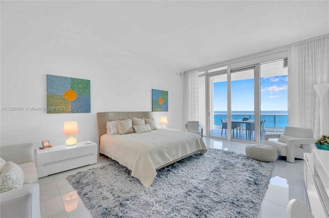 a bedroom with a bed couch and a window