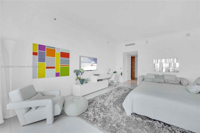 a spacious bedroom with a bed and a couch