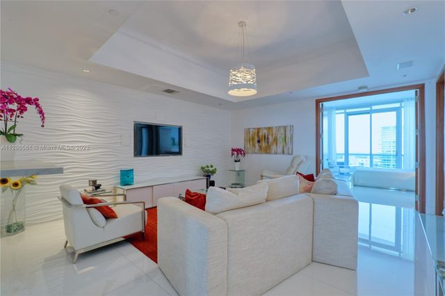 a bedroom with a bed and a large mirror