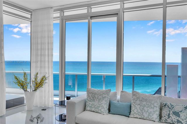 a living room with a couch and a potted plant