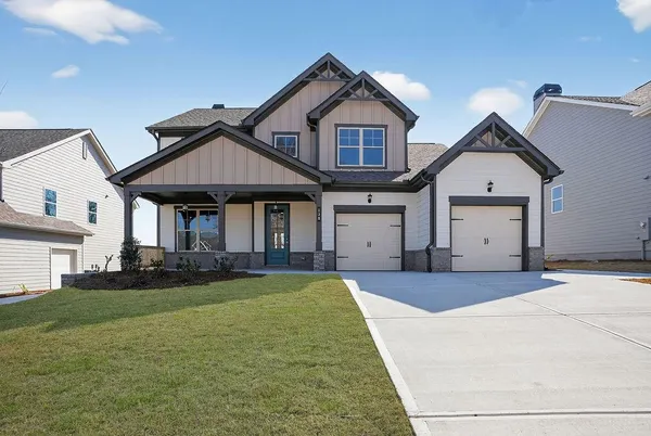 a front view of a house with a yard and garage