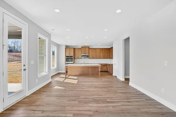 a view of a kitchen with kitchen island and stainless steel appliances