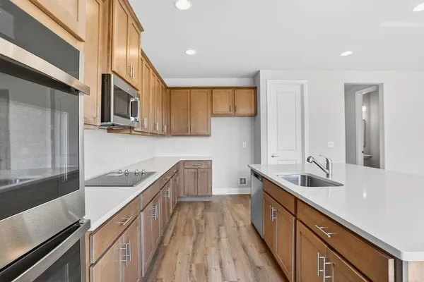a kitchen with a sink and wooden cabinets
