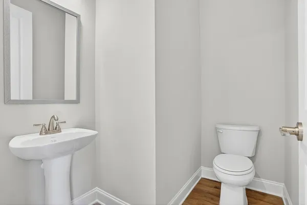 a bathroom with a sink toilet and a mirror