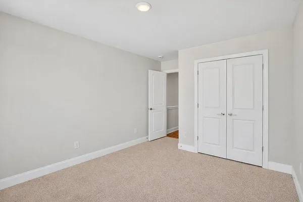 an empty room with windows and wall painting