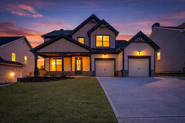a front view of a house with a yard and garage