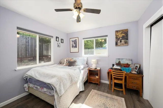 a bedroom with a bed and a large window