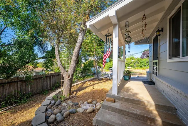 a view of a patio with couple of chairs and a fountain