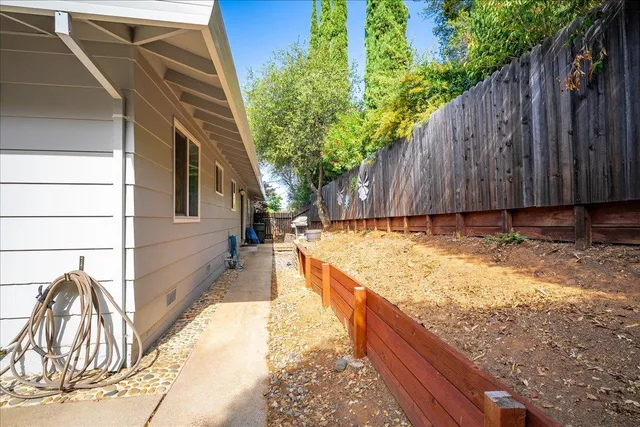 a view of a house with backyard and sitting area