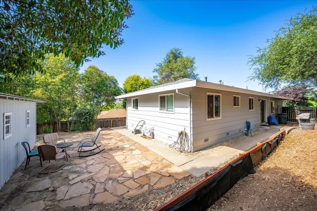 a view of backyard of house and car parked