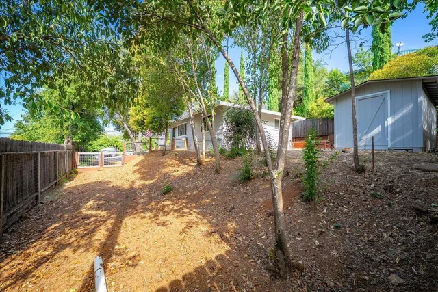 a view of backyard of house with seating space