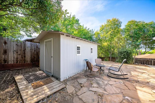 a view of a yard with large trees