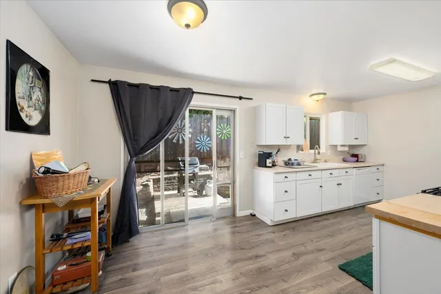 a kitchen with a sink stove and wooden cabinets