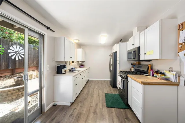 a kitchen with stainless steel appliances a refrigerator and a stove top oven