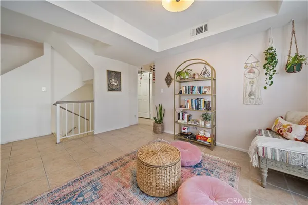 a living room with furniture and baby toys
