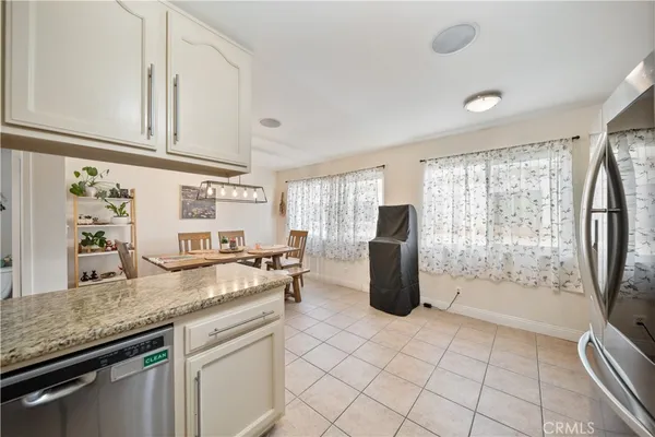a kitchen with refrigerator and window