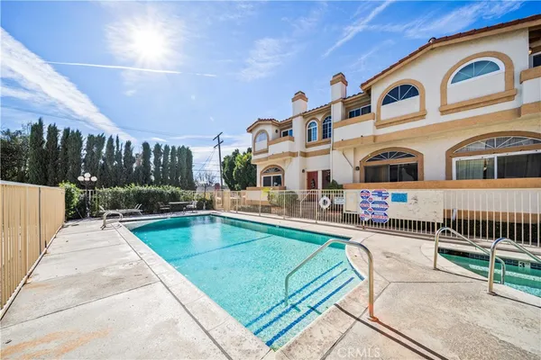 a view of a house with pool and a yard