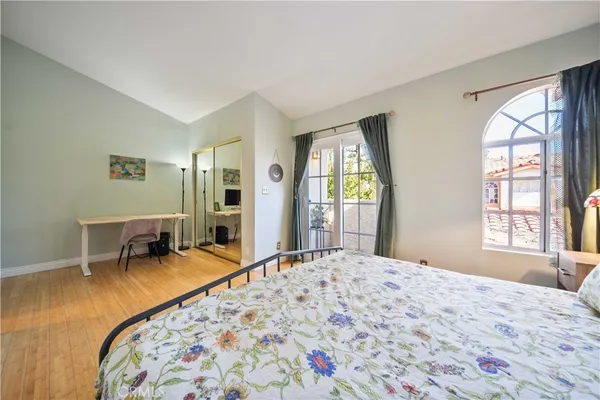 a bedroom with a bed and a large window