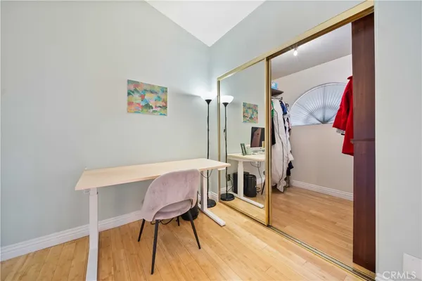 a view of a room with furniture and wooden floor