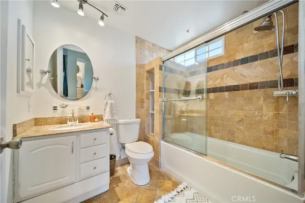 a bathroom with a toilet sink and a mirror
