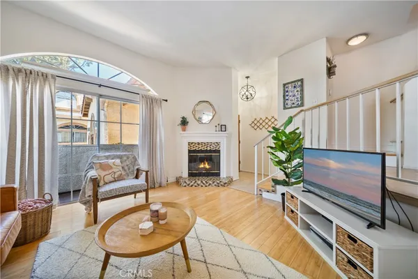 a living room with furniture fireplace and a large window