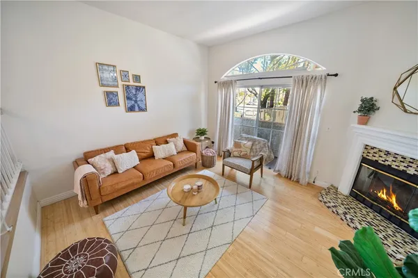 a living room with furniture a fireplace and a chandelier