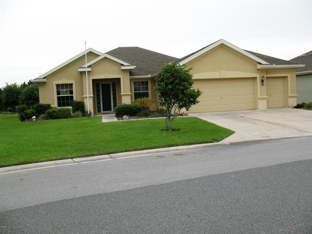 9571 Southwest 71st Loop Ocala, FL 34481 - Photo 1 of 1 a front view of a house with a yard and garage
