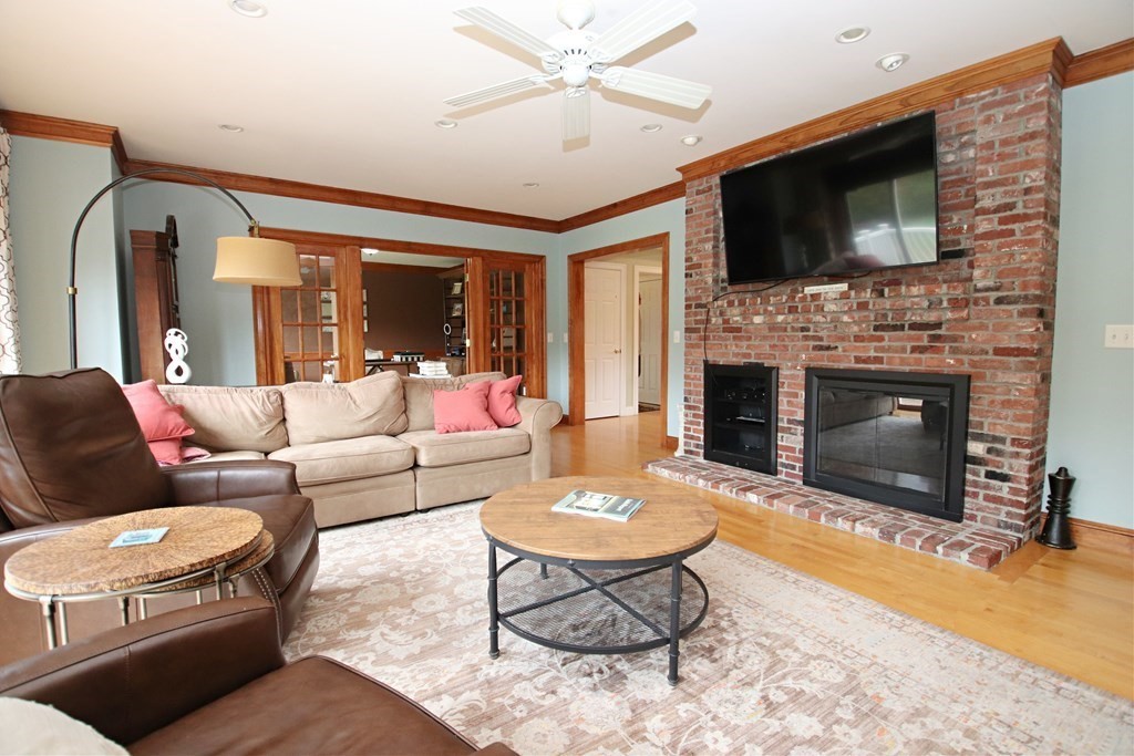 56 Main Street Boxford, MA 01921 - Photo 13 of 42 a living room with furniture a fireplace and a flat screen tv