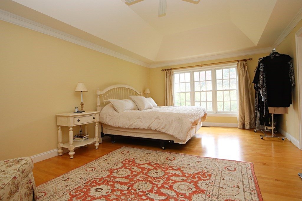 56 Main Street Boxford, MA 01921 - Photo 18 of 42 a bedroom with a bed and wooden floor