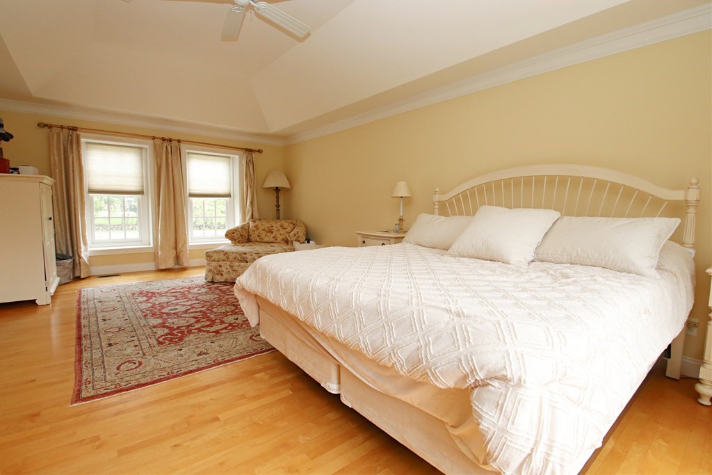 56 Main Street Boxford, MA 01921 - Photo 19 of 42 a bedroom with a bed and wooden floor