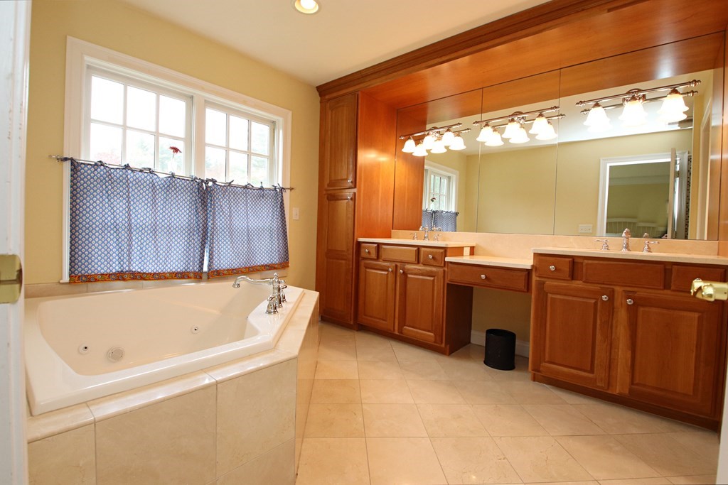 56 Main Street Boxford, MA 01921 - Photo 21 of 42 a bathroom with a tub a sink and a large mirror