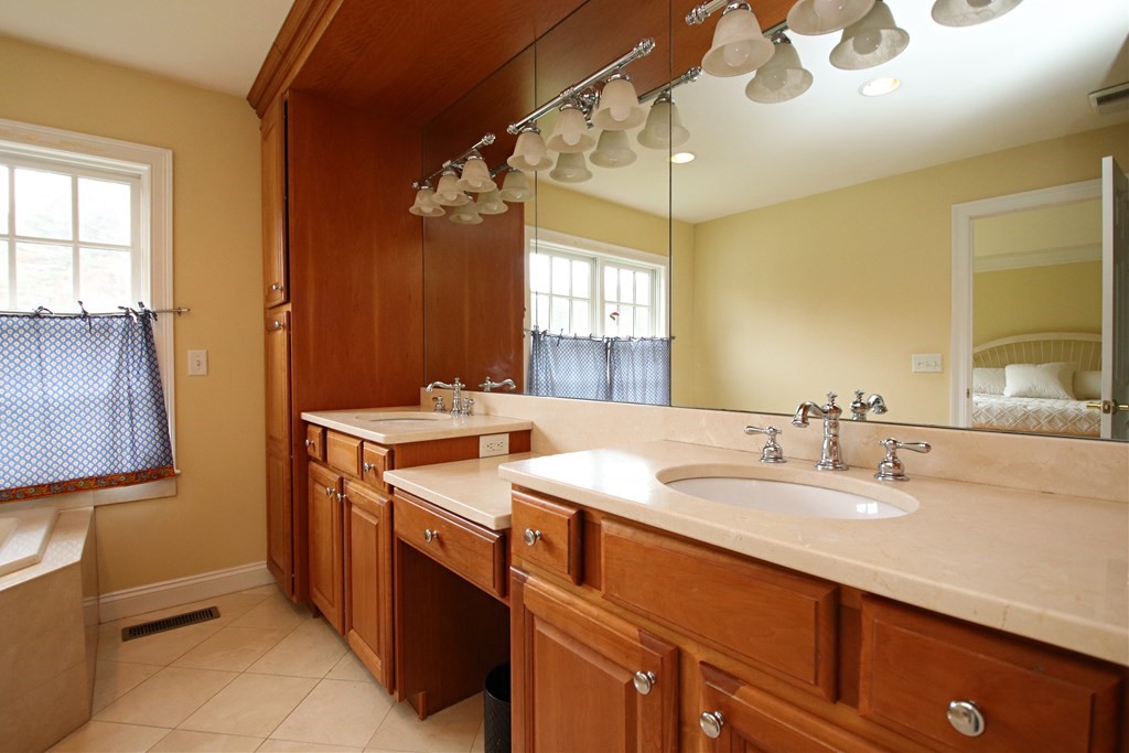 56 Main Street Boxford, MA 01921 - Photo 22 of 42 a bathroom with a sink double vanity and a mirror