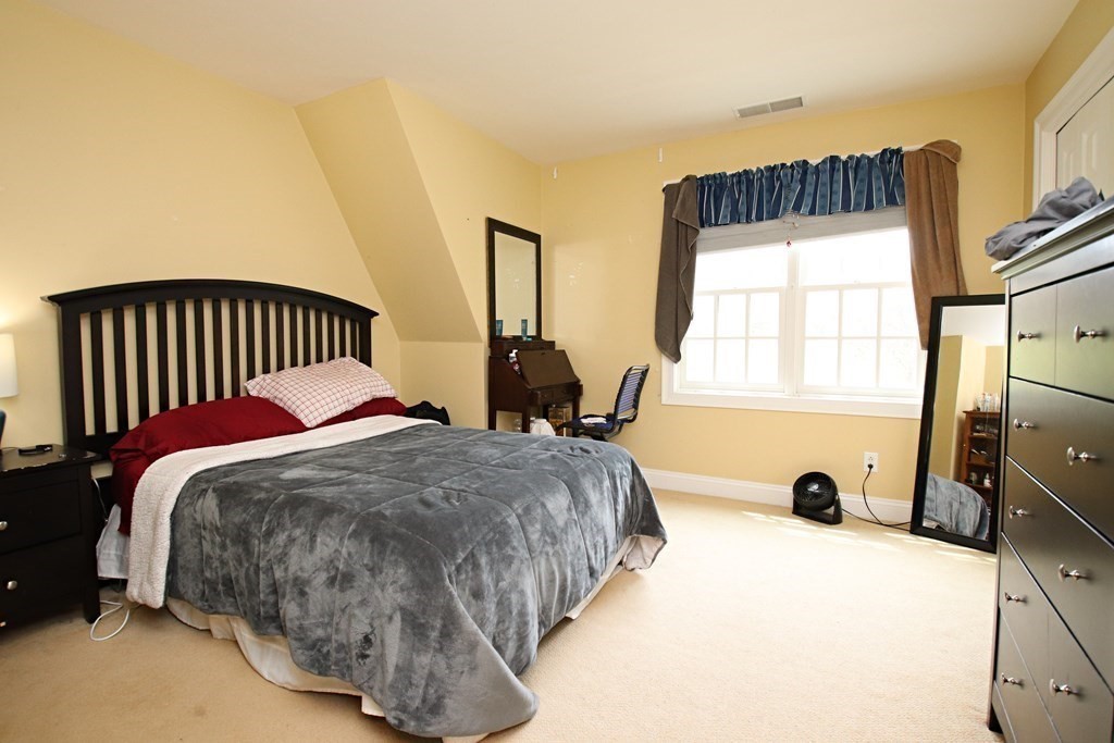 56 Main Street Boxford, MA 01921 - Photo 29 of 42 a bed sitting in a bedroom next to a window