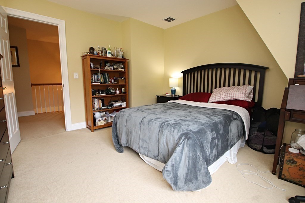 56 Main Street Boxford, MA 01921 - Photo 30 of 42 a bedroom with a bed and a walk in closet