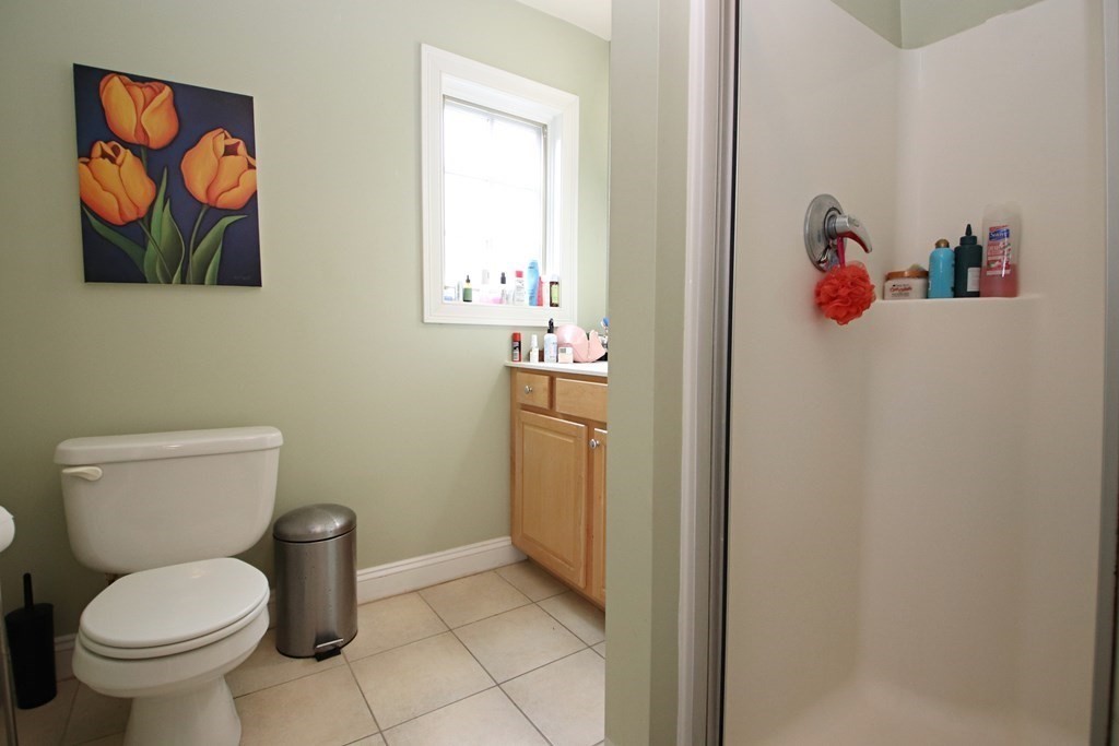 56 Main Street Boxford, MA 01921 - Photo 31 of 42 a bathroom with a toilet and a shower curtain