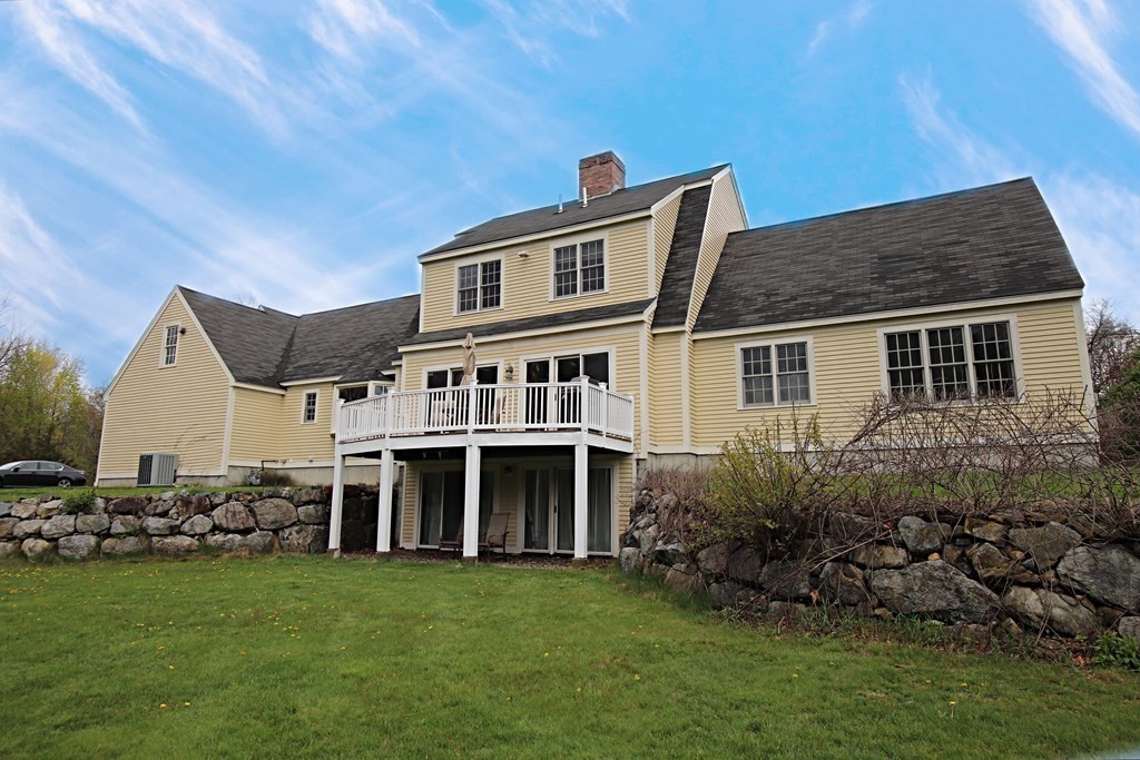56 Main Street Boxford, MA 01921 - Photo 4 of 42 a front view of a house with a garden