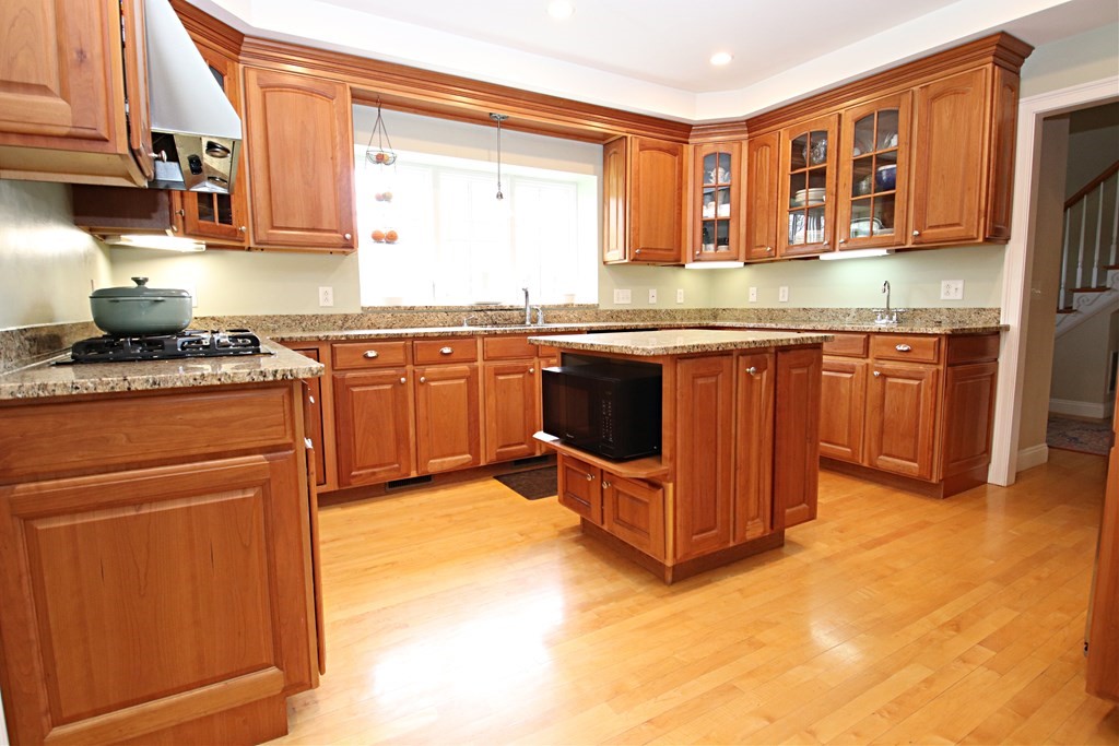 56 Main Street Boxford, MA 01921 - Photo 5 of 42 a kitchen with stainless steel appliances granite countertop a stove sink and cabinets
