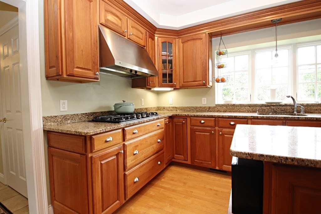 56 Main Street Boxford, MA 01921 - Photo 7 of 42 a kitchen with stainless steel appliances granite countertop a stove a sink and a microwave