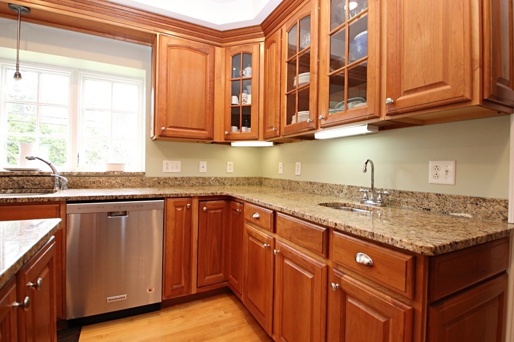 56 Main Street Boxford, MA 01921 - Photo 8 of 42 a kitchen with stainless steel appliances granite countertop a sink dishwasher and cabinets with wooden floor