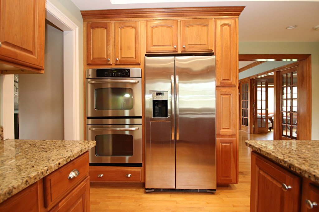 56 Main Street Boxford, MA 01921 - Photo 9 of 42 a kitchen with granite countertop a refrigerator and microwave
